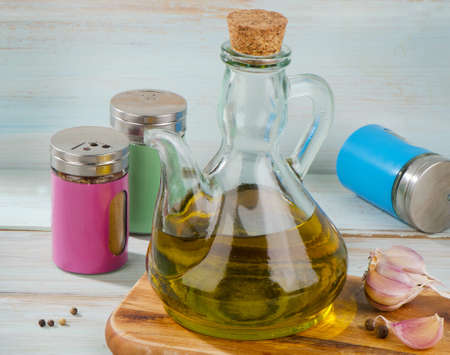Olive oil and spices on a wooden table. Selective focusの写真素材