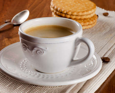 Coffee cup and cookies on wooden table. Selective focusの写真素材