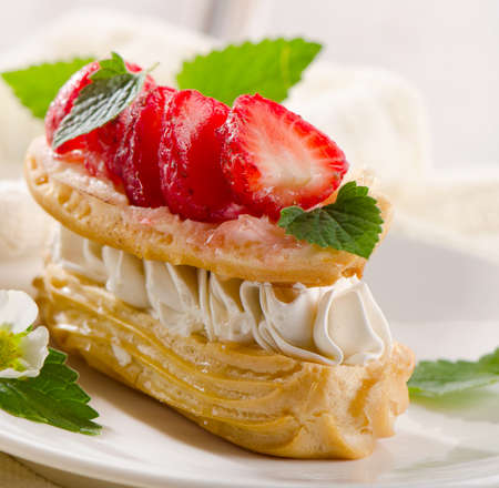 Sweet cream puff with strawberries. Selective focusの写真素材