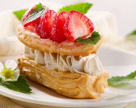 Sweet cream puff with strawberries. Selective focusの写真素材