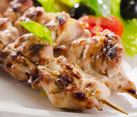 Grilled chicken  kebab  served with fresh salad. Selective focusの写真素材