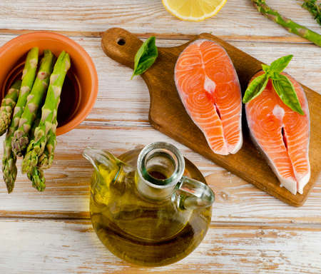 Healthy food  ingredients - salmon, vegetables  on  a wooden table.の写真素材