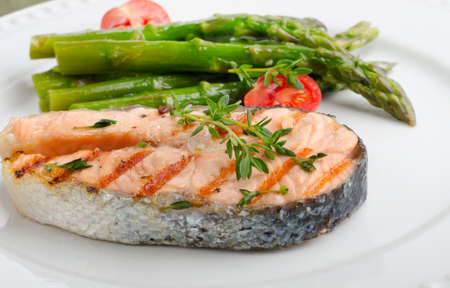 Grilled salmon with asparagus   on a white plate. Selective focusの写真素材