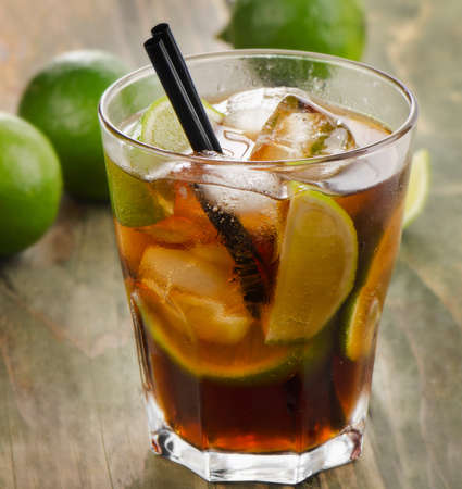 Cuba Libre cocktail with lime on a wooden table. Selective focusの写真素材