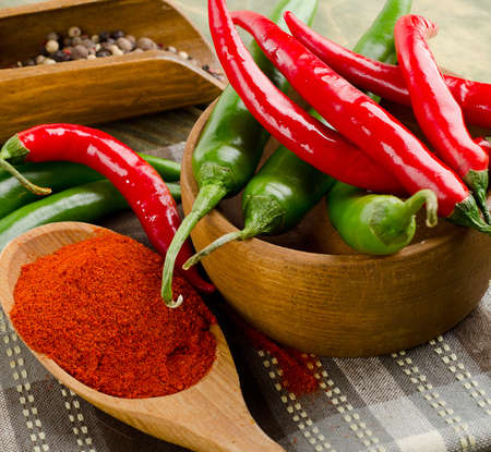 Red and green Chili Peppers on a wooden background. Selective focusの写真素材