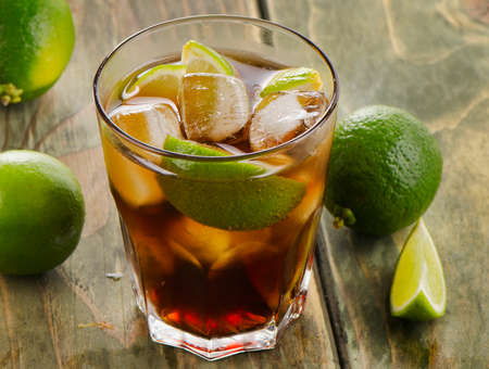 Cuba Libre  with lime on a wooden table. Selective focusの写真素材