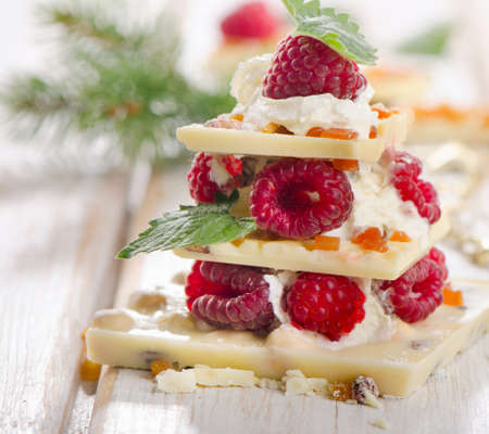 Sweet chocolate christmas tree with berries . Selective focusの写真素材