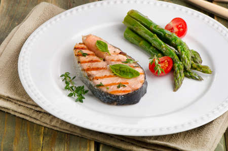 Salmon with  asparagus  and  herbs on white plate. Selective focusの写真素材