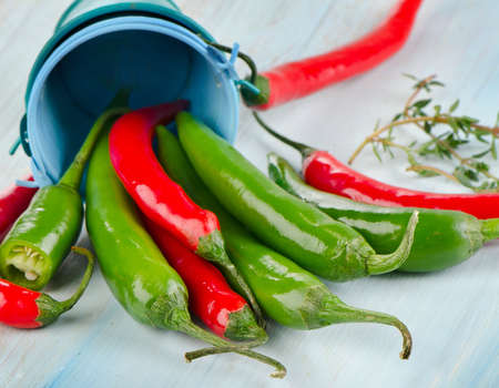 Red and green Chili Peppers on  wooden table.  Selective focusの写真素材