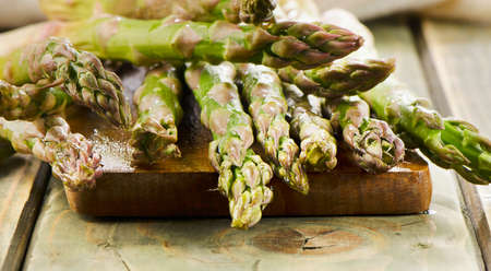 Bunch of fresh asparagus on wooden table. Selective focusの写真素材