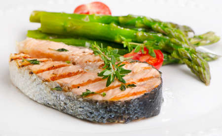 Grilled salmon with vegetables   on a white plate. Selective focusの写真素材