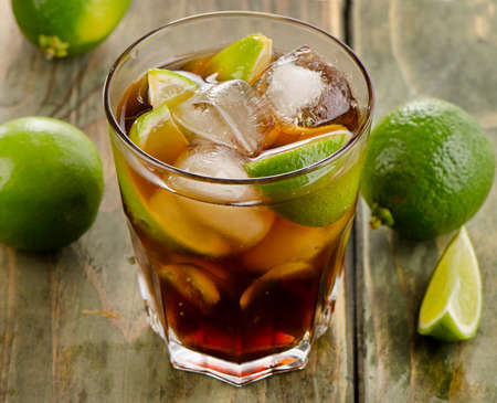 Cuba Libre cocktail with lime on  wooden table. Selective focusの写真素材