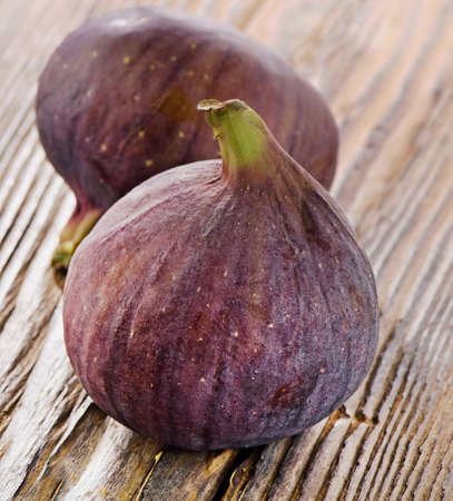 Two  figs on a wooden background . Selective focusの写真素材