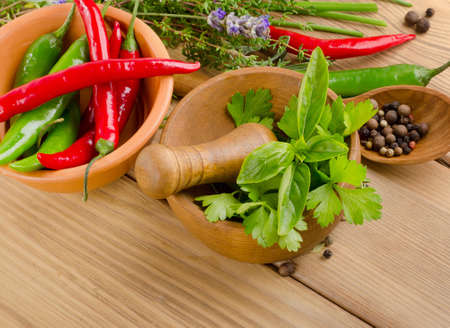 Herbs and peppers on  wooden background. Selective focusの写真素材