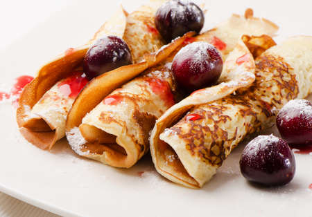 pancakes with cherries on a white plate. Selective focusの写真素材