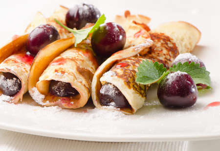 pancakes with cherries on  white plate. Selective focusの写真素材
