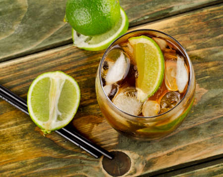 Cuba Libre Drink with lime on a wooden table. Selective focusの写真素材