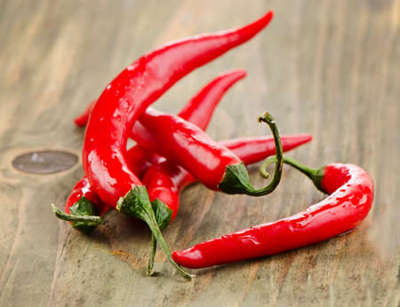 Red  chili peppers on a wooden board. Selective focusの写真素材