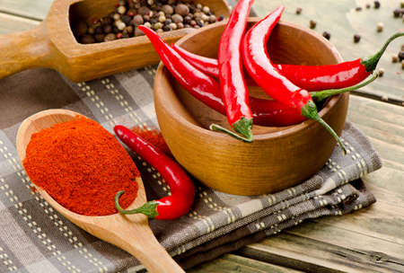 Chili peppers on in a spoon  on wooden background . Selective focusの写真素材