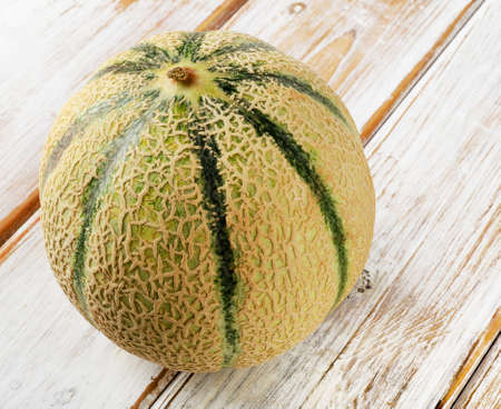 Whole melon  on a wooden background. Selective focusの写真素材