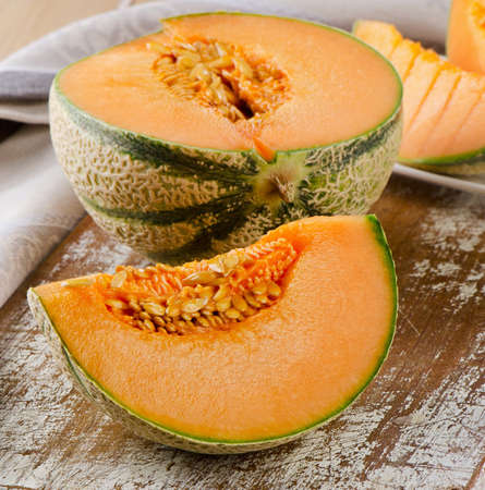 Fresh cantaloupe melon on  wooden board. Selective focusの写真素材