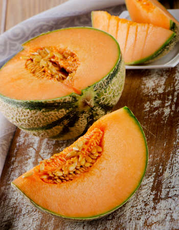 Fresh cantaloupe melon on  wooden table. Selective focusの写真素材