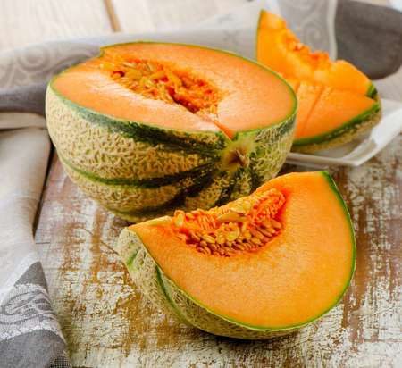 Fresh cantaloupe melon on a wooden table. Selective focusの写真素材