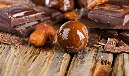 Chocolate bar and nuts  on  wooden table. Selective focusの写真素材