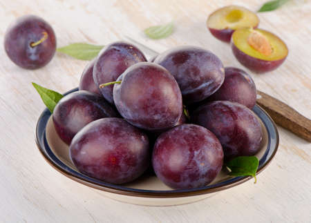 Plums on a  wooden background.  Selective focusの写真素材