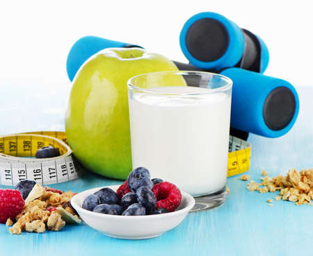 dumbbells with  healthy food and drink on  blue bakground. Selective focusの写真素材