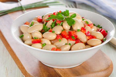 Salad with white beans on a wooden board. Selective focusの写真素材