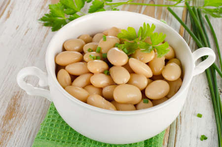 Beans  with fresh herbs  on  wooden table. Selective focusの写真素材