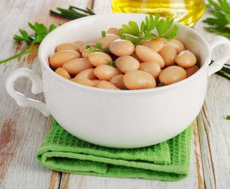 Beans  with fresh herbs  on  a wooden table. Selective focusの写真素材