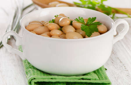 Beans  with fresh parsley  on  a wooden table. Selective focusの写真素材