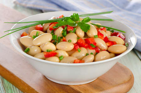 White bean salad   on a wooden board. Selective focusの写真素材