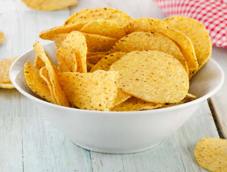 Corn nachos chips on a wooden table. Selective focusの写真素材