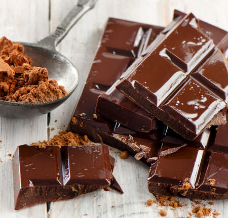 Cocoa powder and broken chocolate bar and  on a wooden table. Selective focusの写真素材
