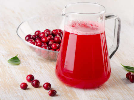 Cranberry drink with fresh berries on a woodenの写真素材