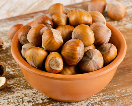 Hazelnuts on old woodenの写真素材