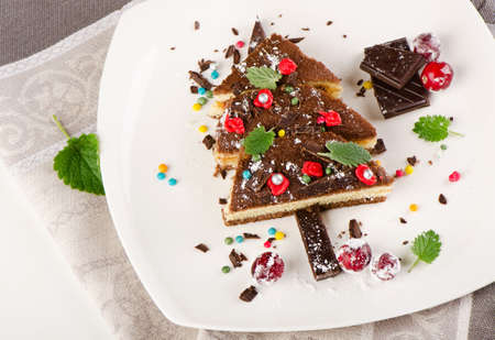 Tree made of  sweet cake with christmas decorations  . Selective focusの写真素材