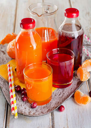 Bottles of Fresh juices on a wooden background. Selective focusの写真素材