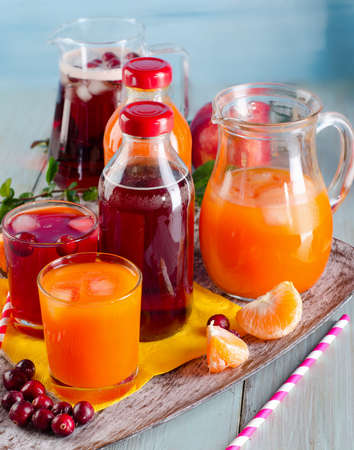 Bottles of Fresh juices on  wooden background. Selective focusの写真素材