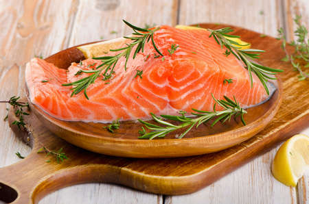 Raw salmon fillet on a cutting board. Selective focusの写真素材