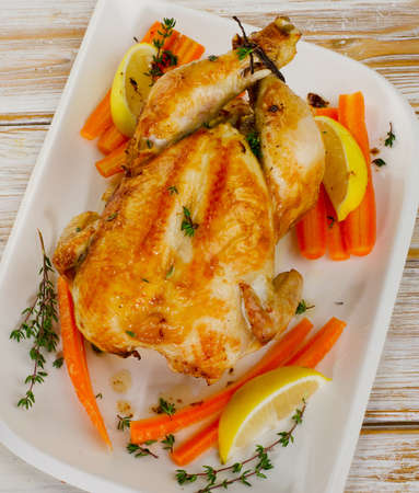 whole roasted chicken  on  a wooden board. Selective focusの写真素材