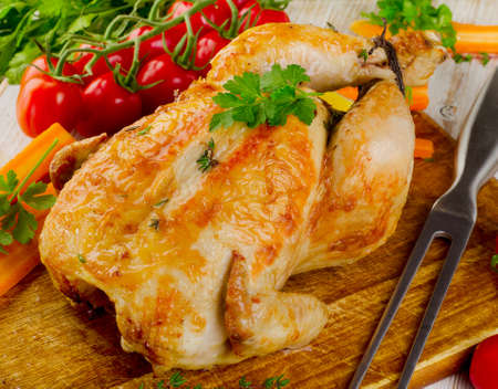 Roasted chicken with vegetables on  a wooden board. Selective focusの写真素材