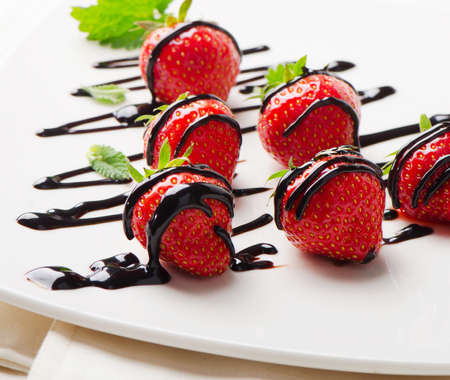 Fresh strawberries dipped in chocolate sauce. Selective focusの写真素材