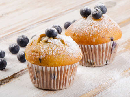 Blueberries muffins   on a  wooden background. Selective focusの写真素材
