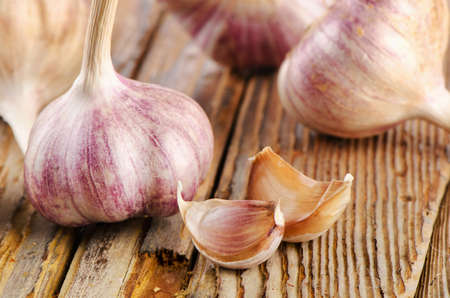 garlic whole and cloves on  a wooden board. selective focusの写真素材