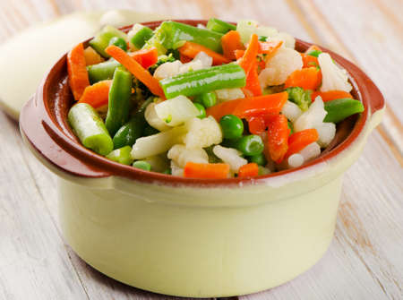 Mixed vegetables in  bowl on a wooden tableの写真素材
