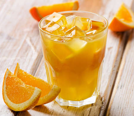 Orange juice  with  fresh fruits on  a wooden background. Selective focusの写真素材